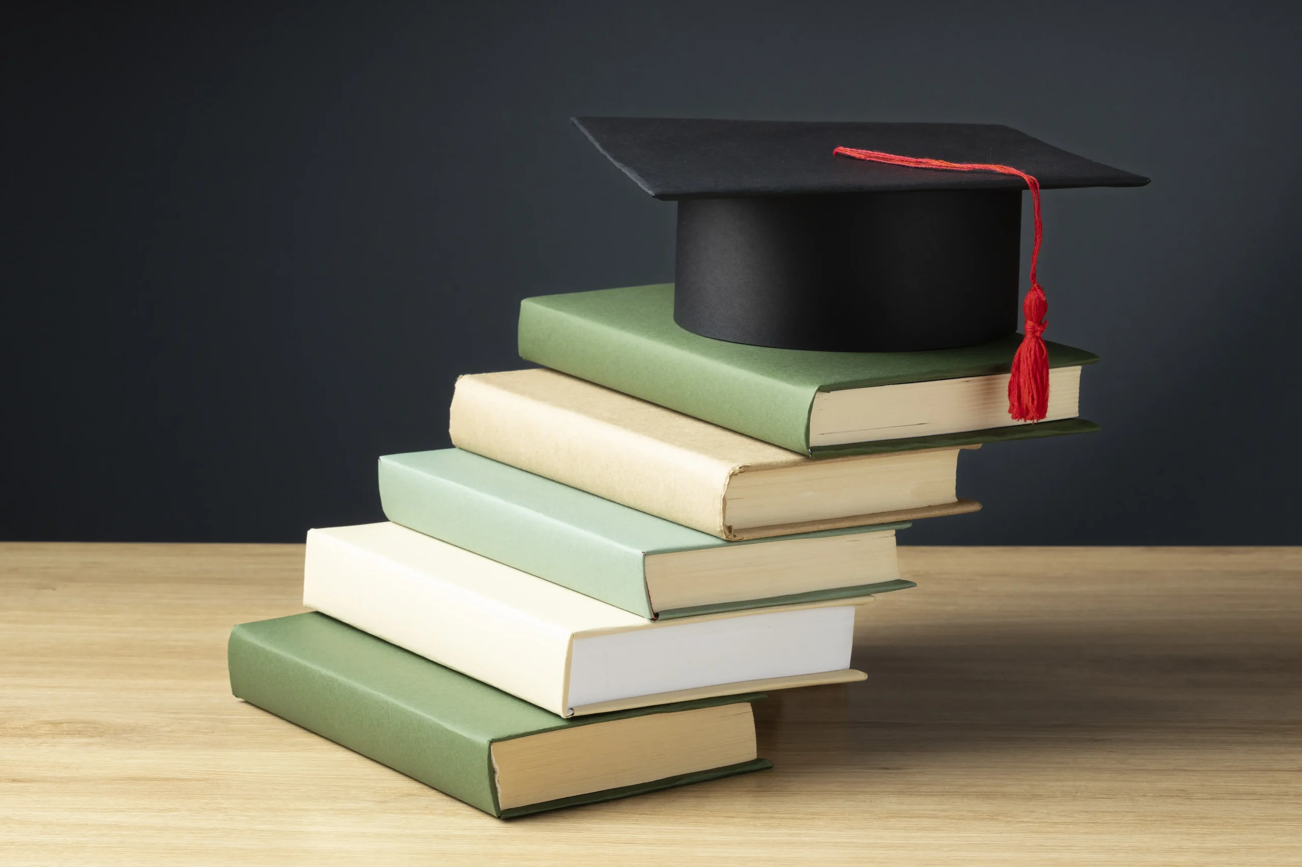 high-angle-books-graduation-cap-education-day high-angle-books-graduation-cap-education-day